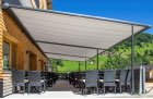 Image of pergolas fitted over seating area outside a cafe.