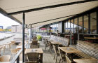 Image of pergolas fitted over seating area of a North Sea cafe.