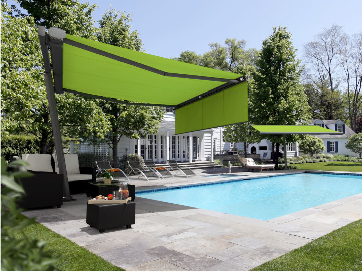 Image of freestanding planet fitted with retractable awnings providing shade next to a garden swimming pool